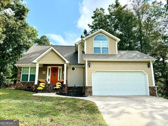 a front view of a house with a yard and garage