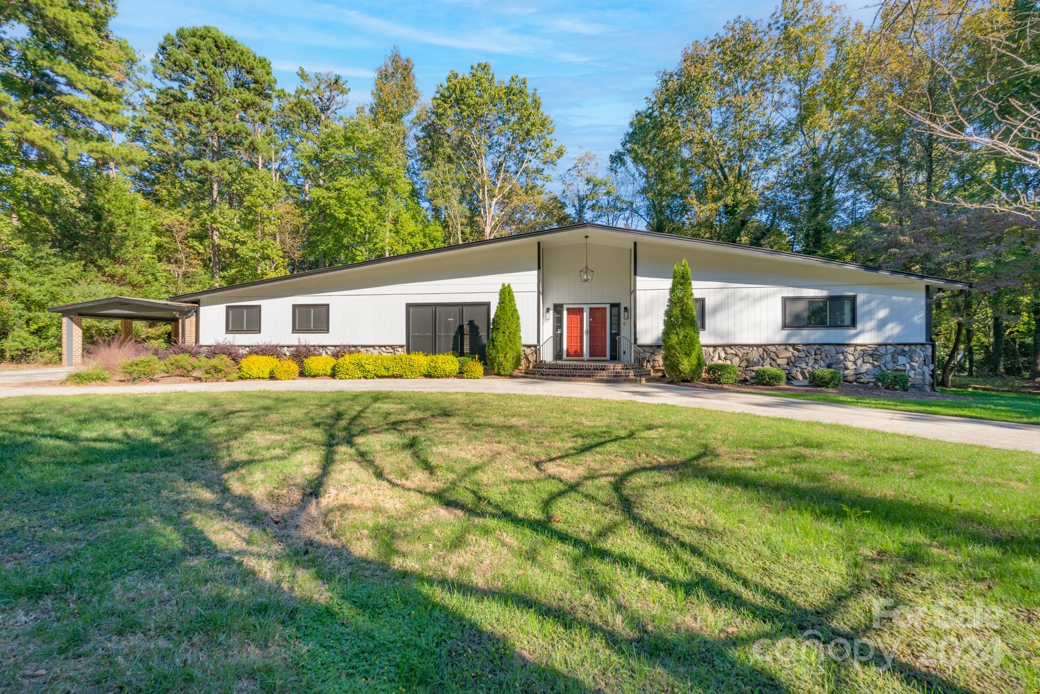 a front view of house with yard and outdoor seating