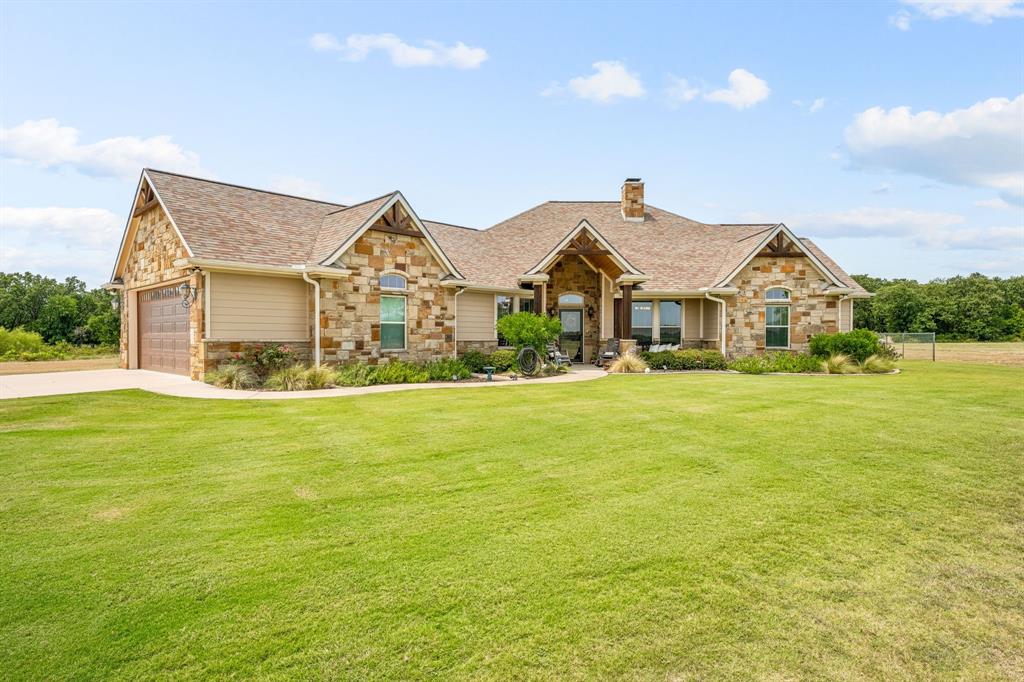 a front view of house with yard and green space