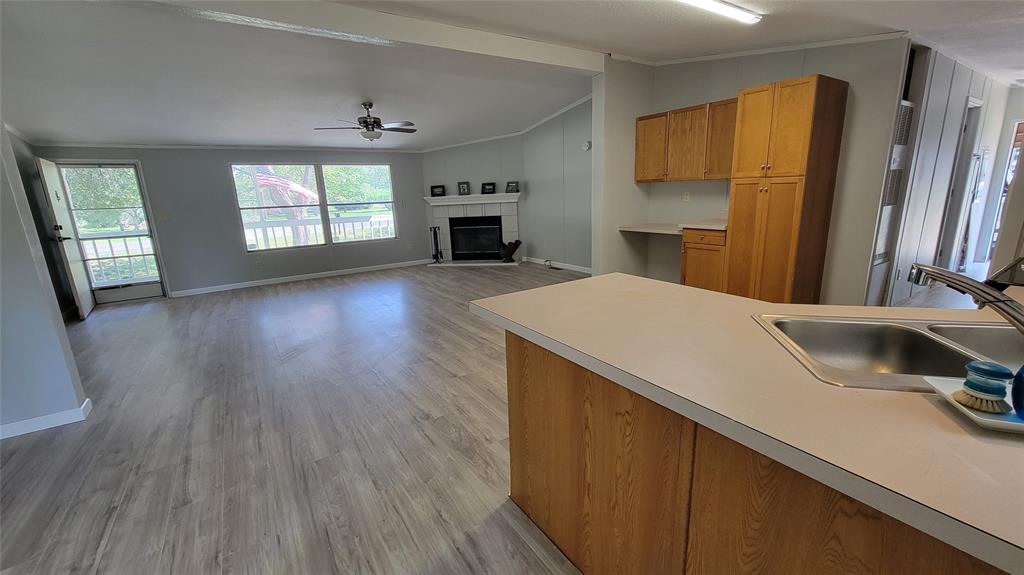 a kitchen with kitchen island a sink appliances and a counter top space