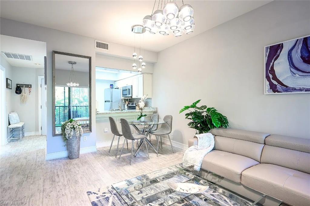 a living room with furniture and a chandelier