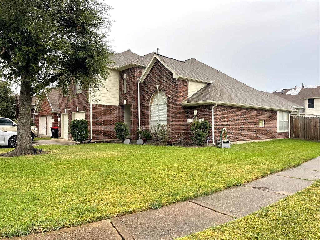 a front view of a house with a garden and yard