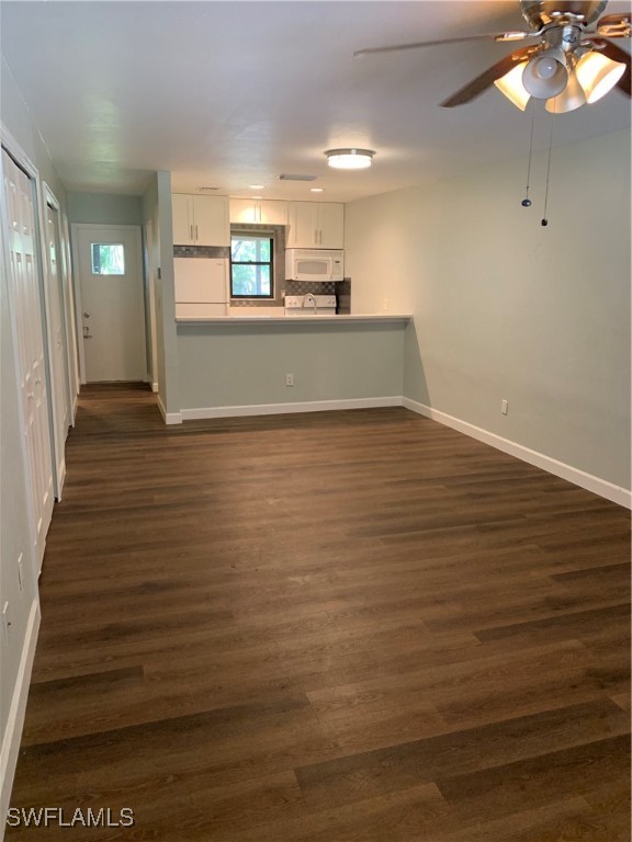 a view of a kitchen with a sink and cabinets