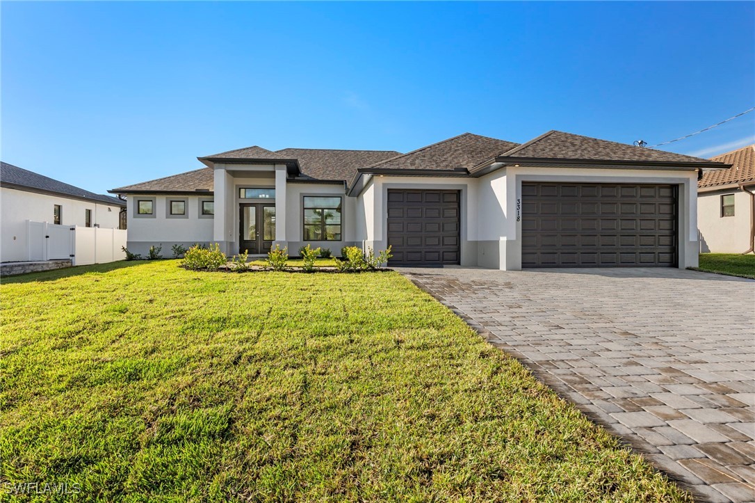 a front view of a house with yard and garage