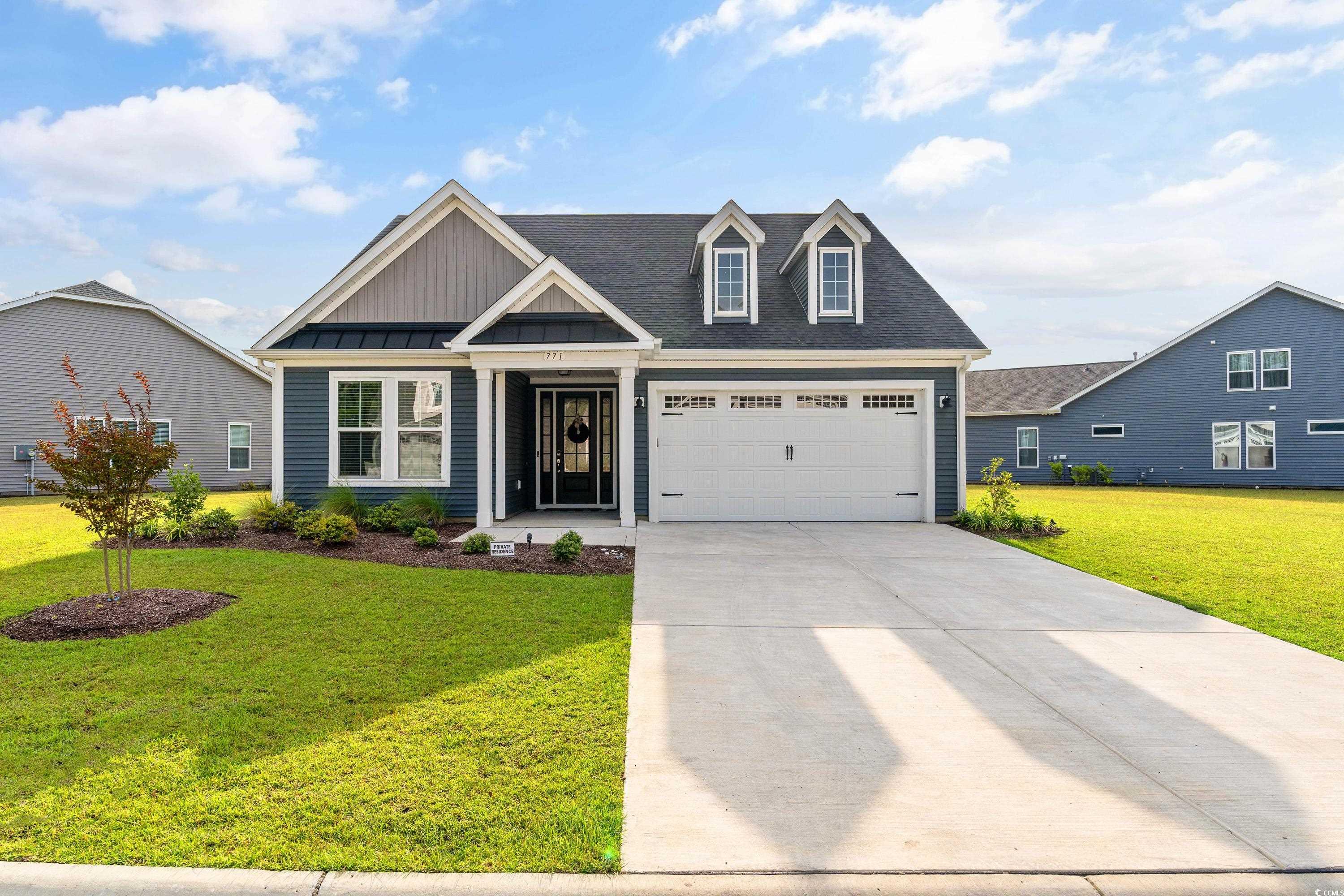 View of front of home featuring a garage and a fro