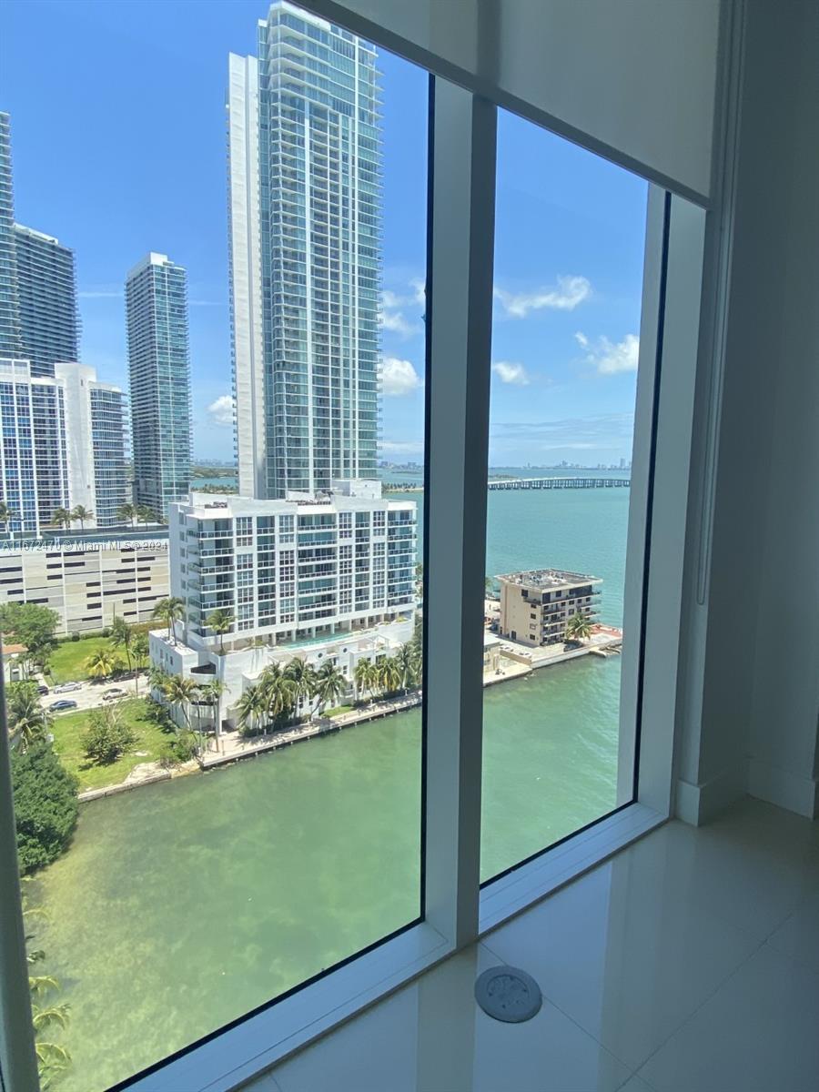 a view of a glass door with a lake view