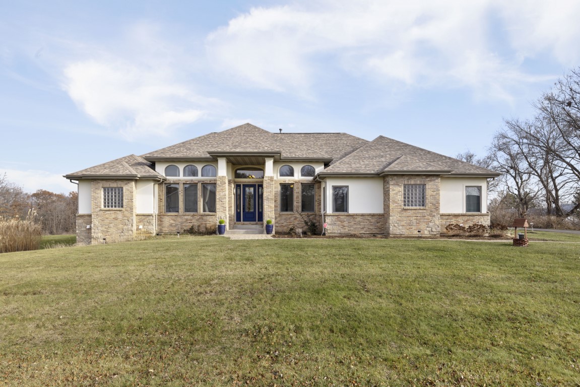 a front view of a house with a garden