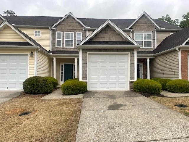 a view of a house with a yard and garage