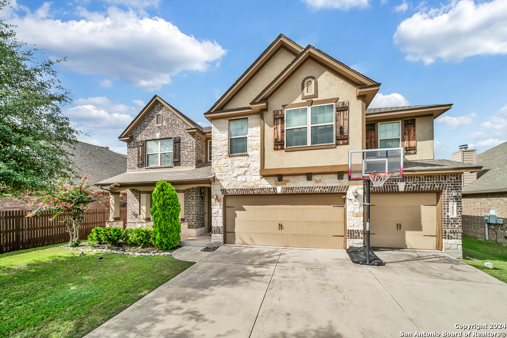 a front view of a house with a yard and garage