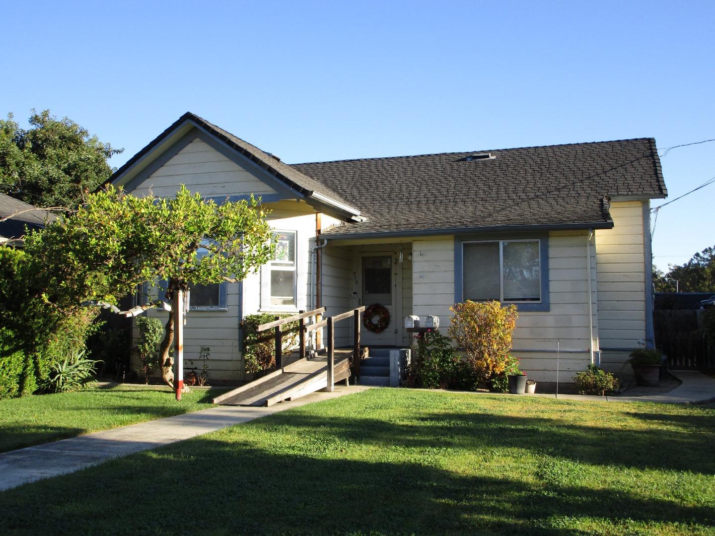 a view of a house with backyard and porch