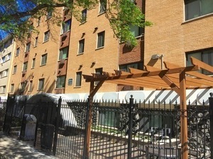 a view of a patio with table and chairs with wooden fence and plants