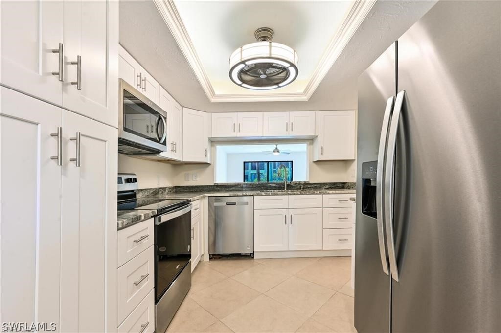 a kitchen with stainless steel appliances granite countertop a stove and a refrigerator