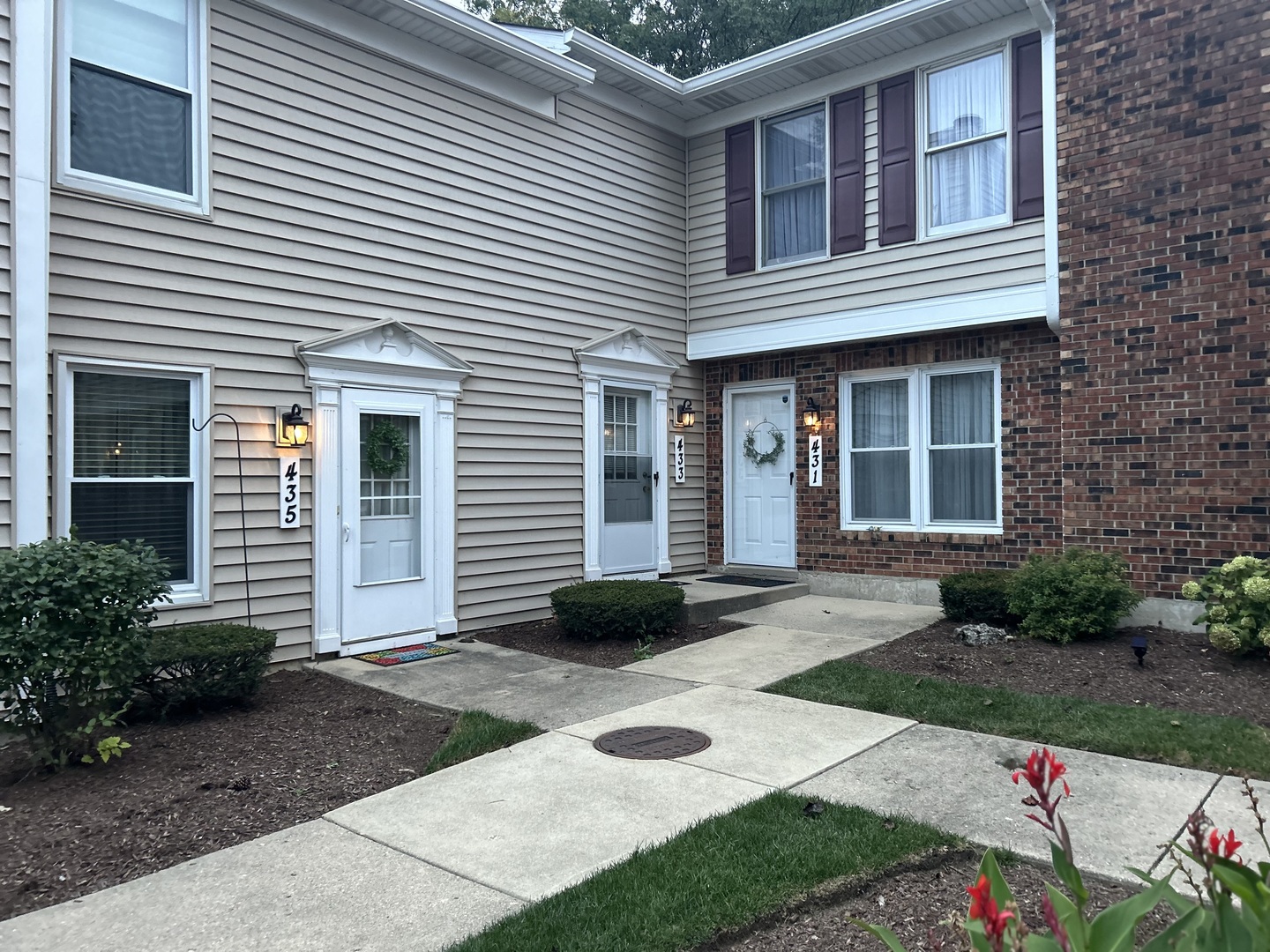 a front view of a house with garden