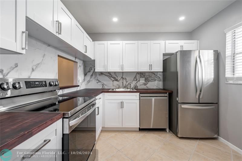 a kitchen with a refrigerator stove and sink