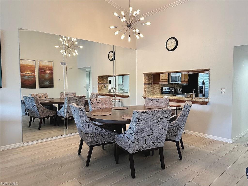 a view of a dining room with furniture and chandelier