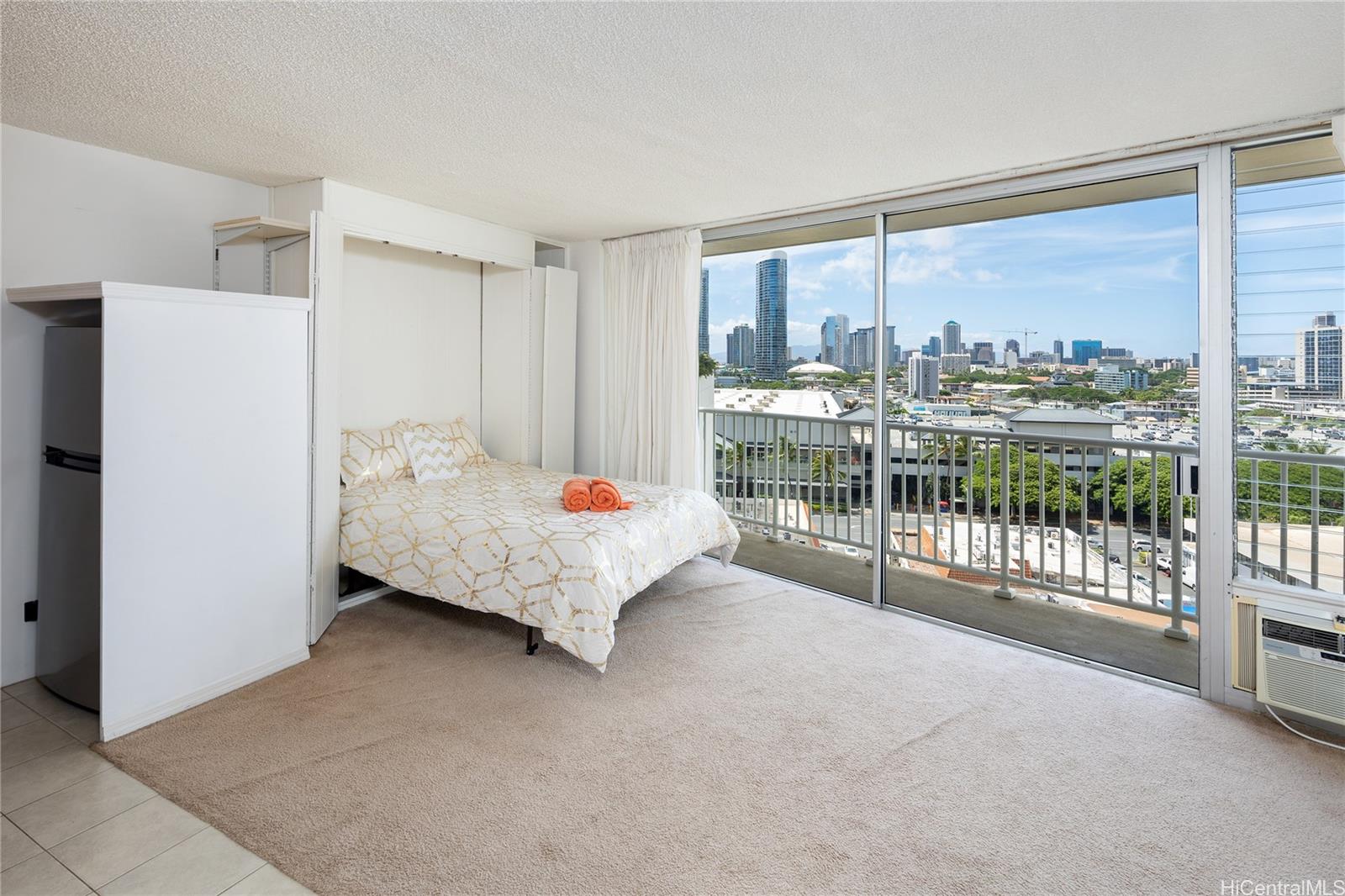 a bedroom with a bed and a large window