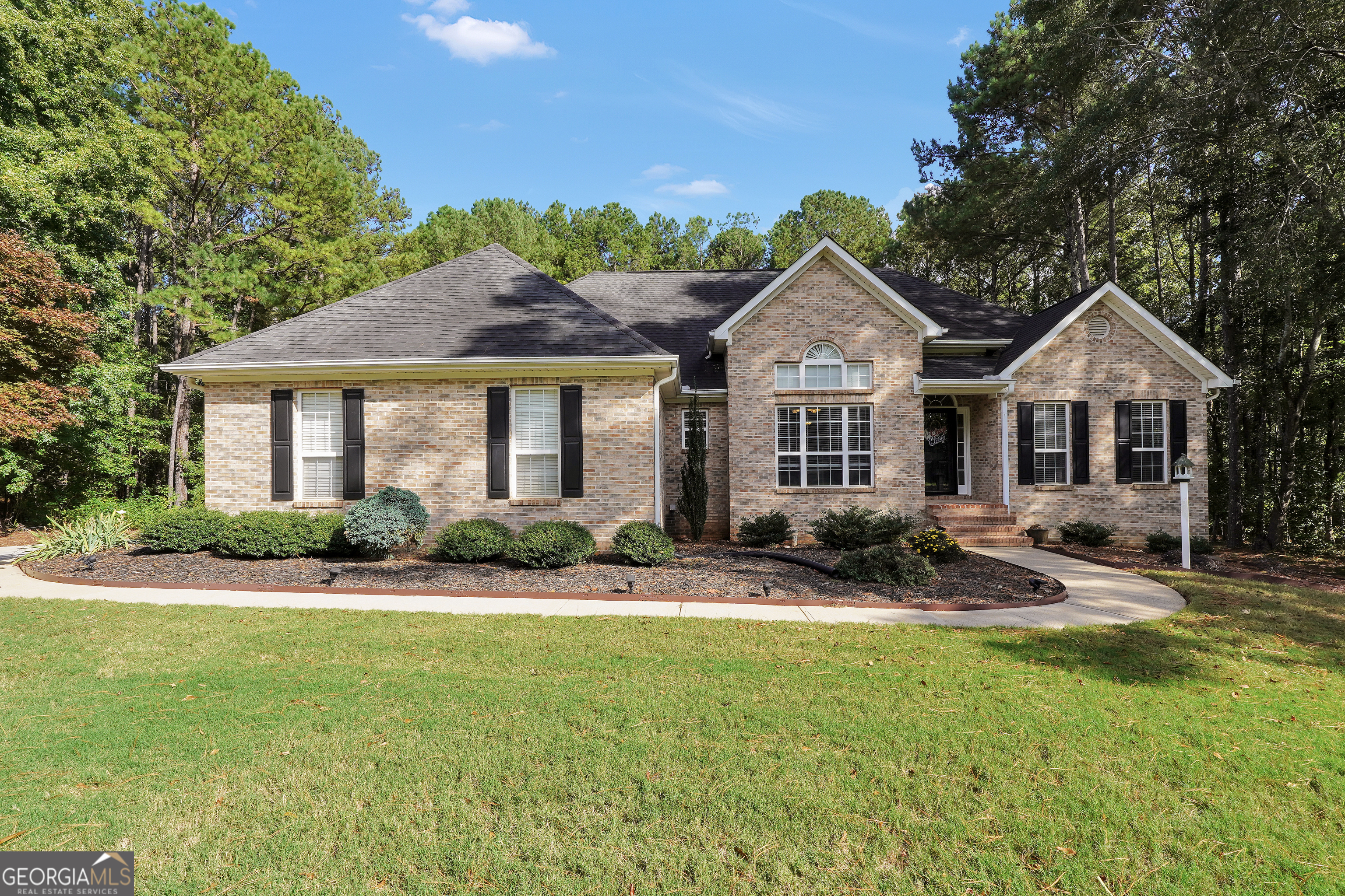 a front view of a house with a yard