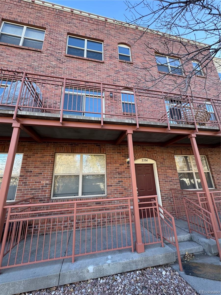 a view of a brick building with many windows