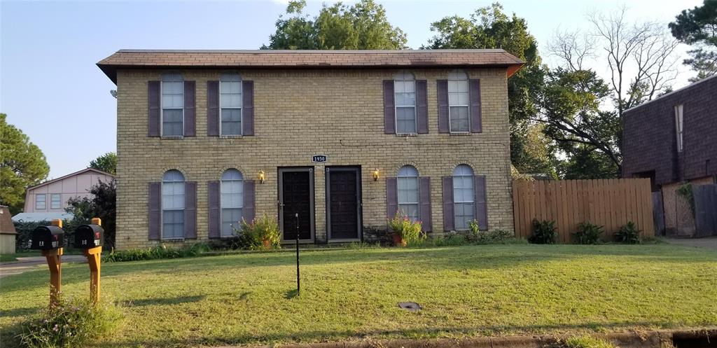 a brick building with a yard in front of it