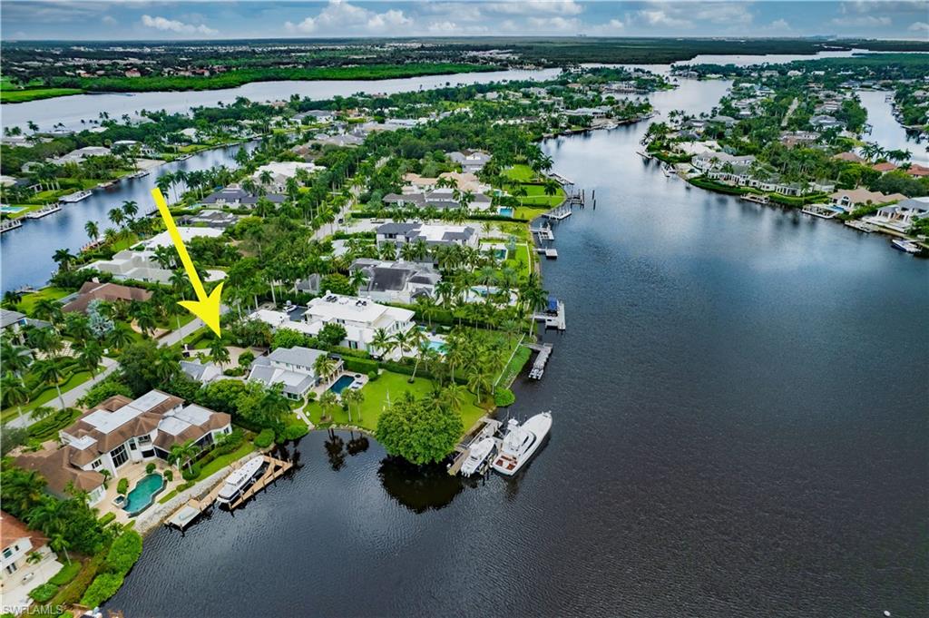 an aerial view of a house with a yard and lake view