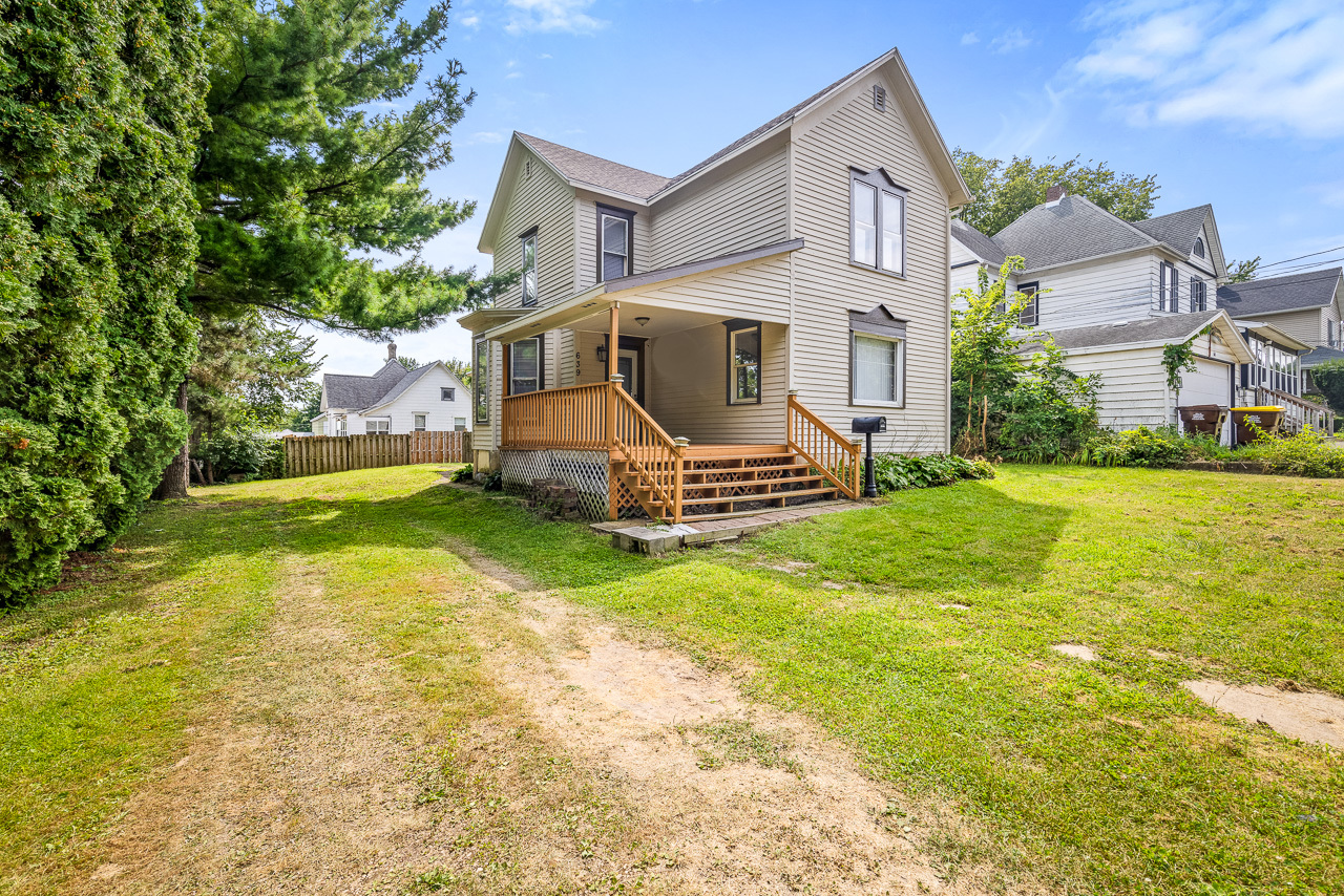 a front view of a house with a yard