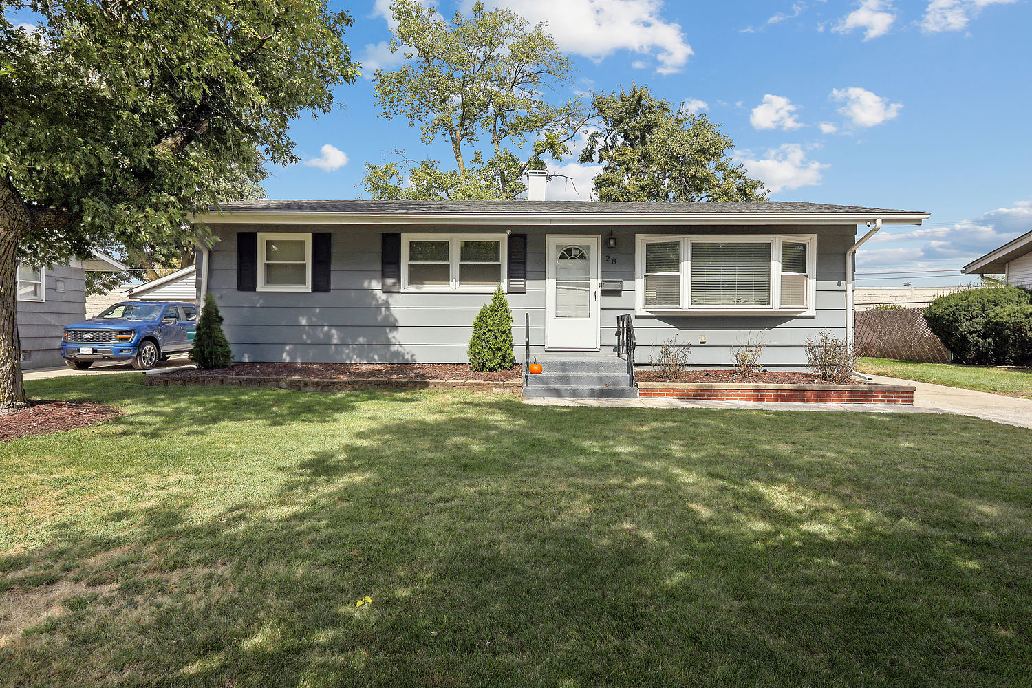 a house view with outdoor seating space and garden