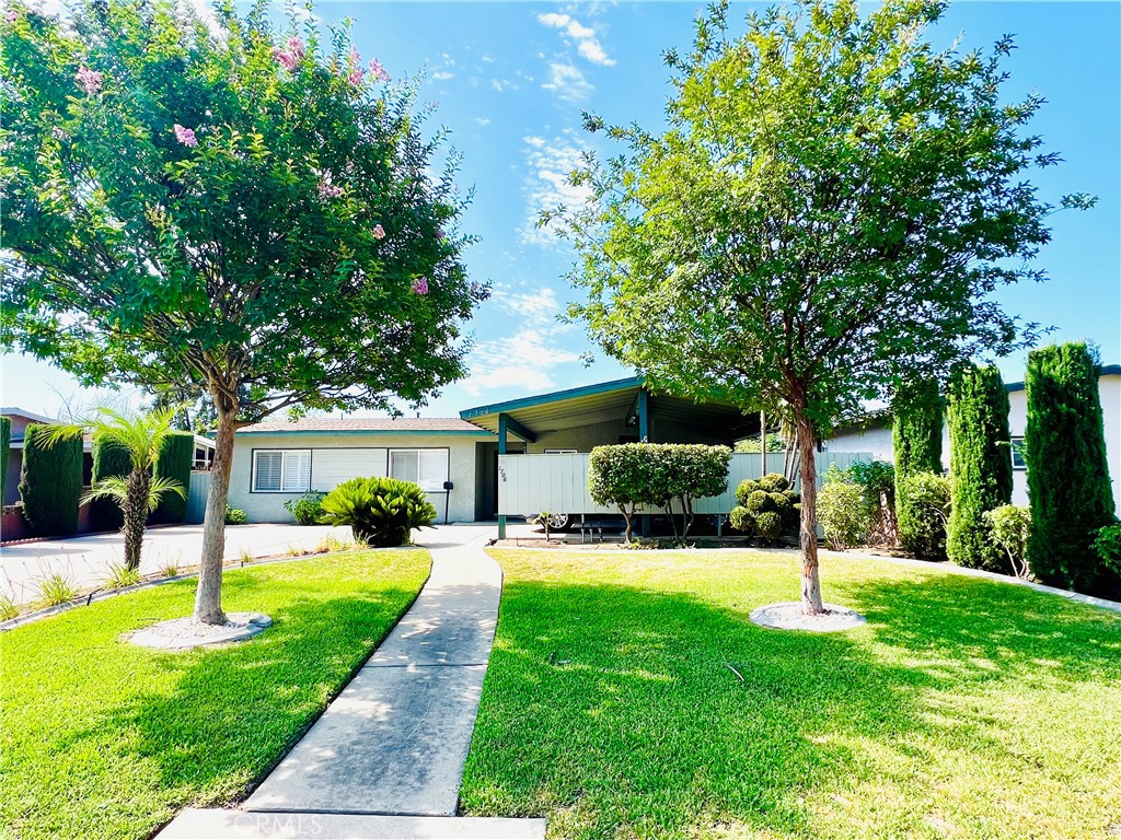 a view of a house with a backyard