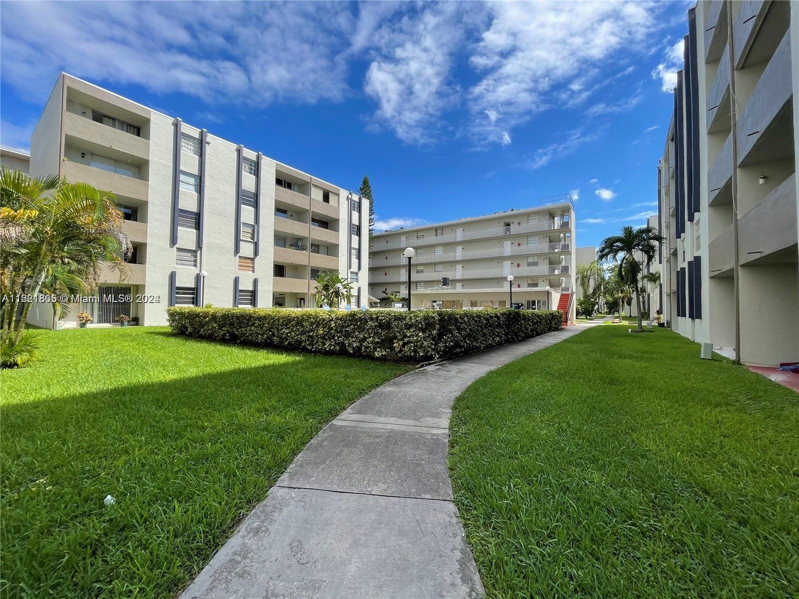 a view of a building with a yard