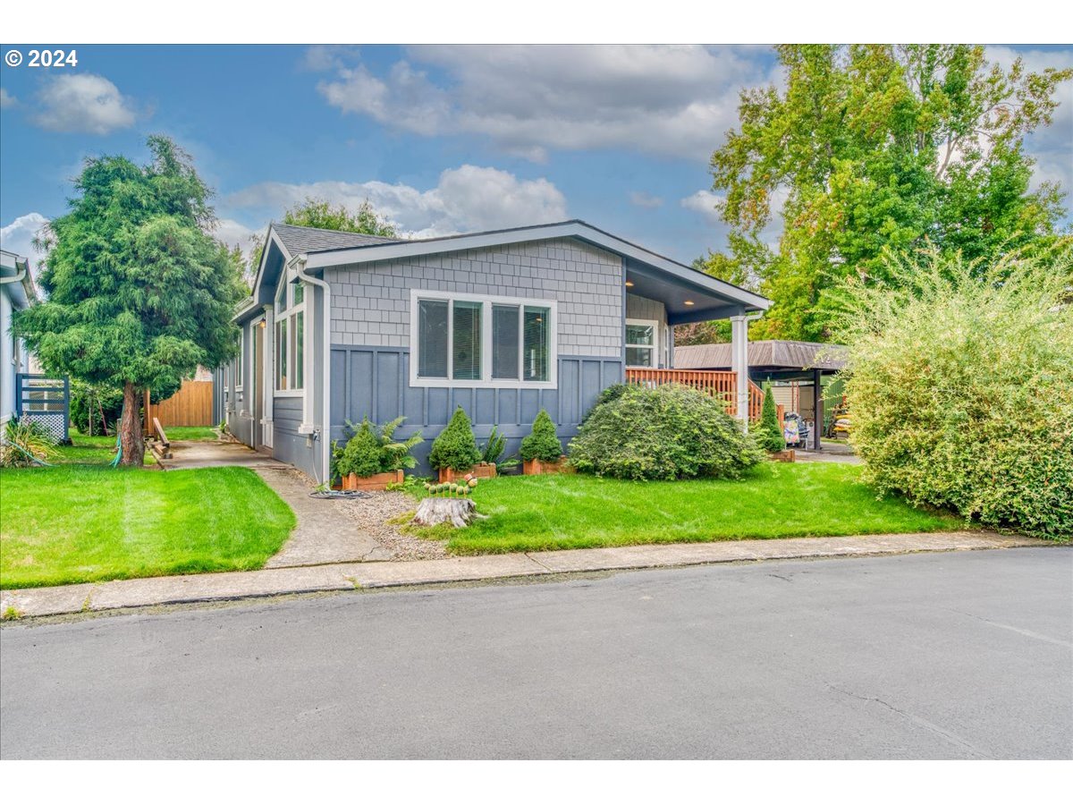 a front view of house with yard and green space