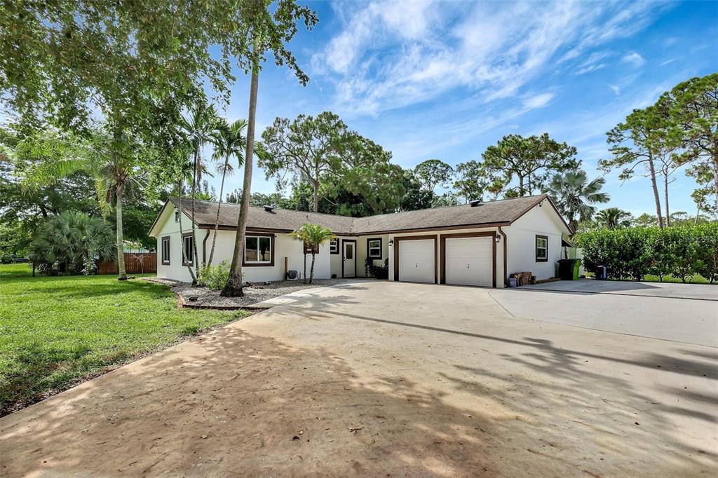 a front view of house with yard and trees