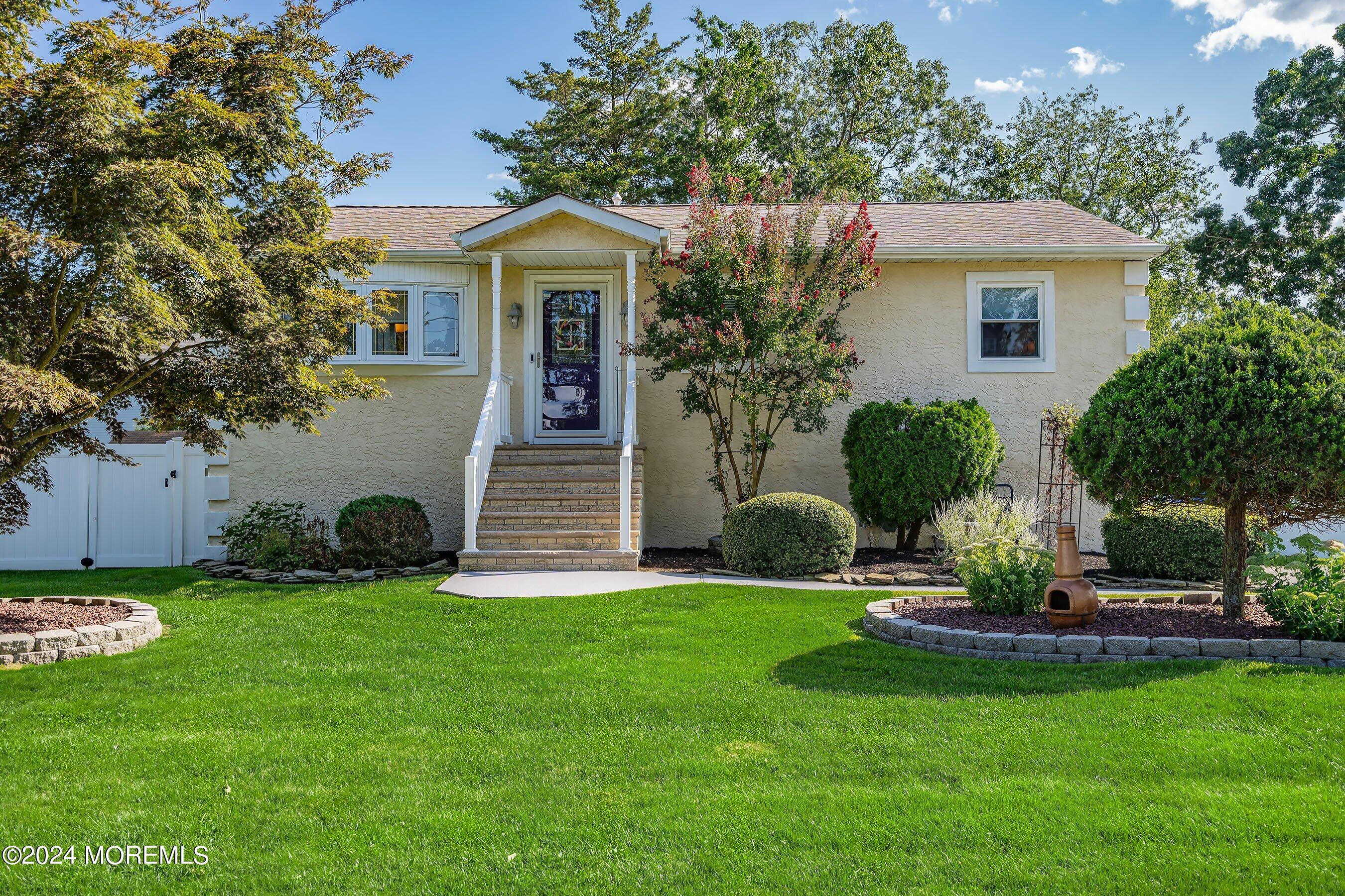 a front view of a house with a garden