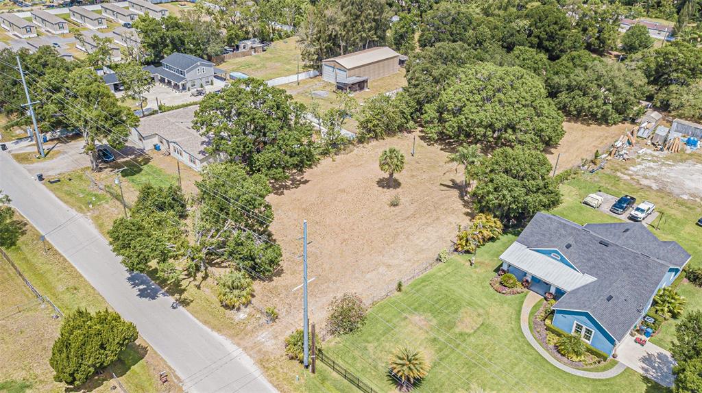 an aerial view of a house with a yard and lake view