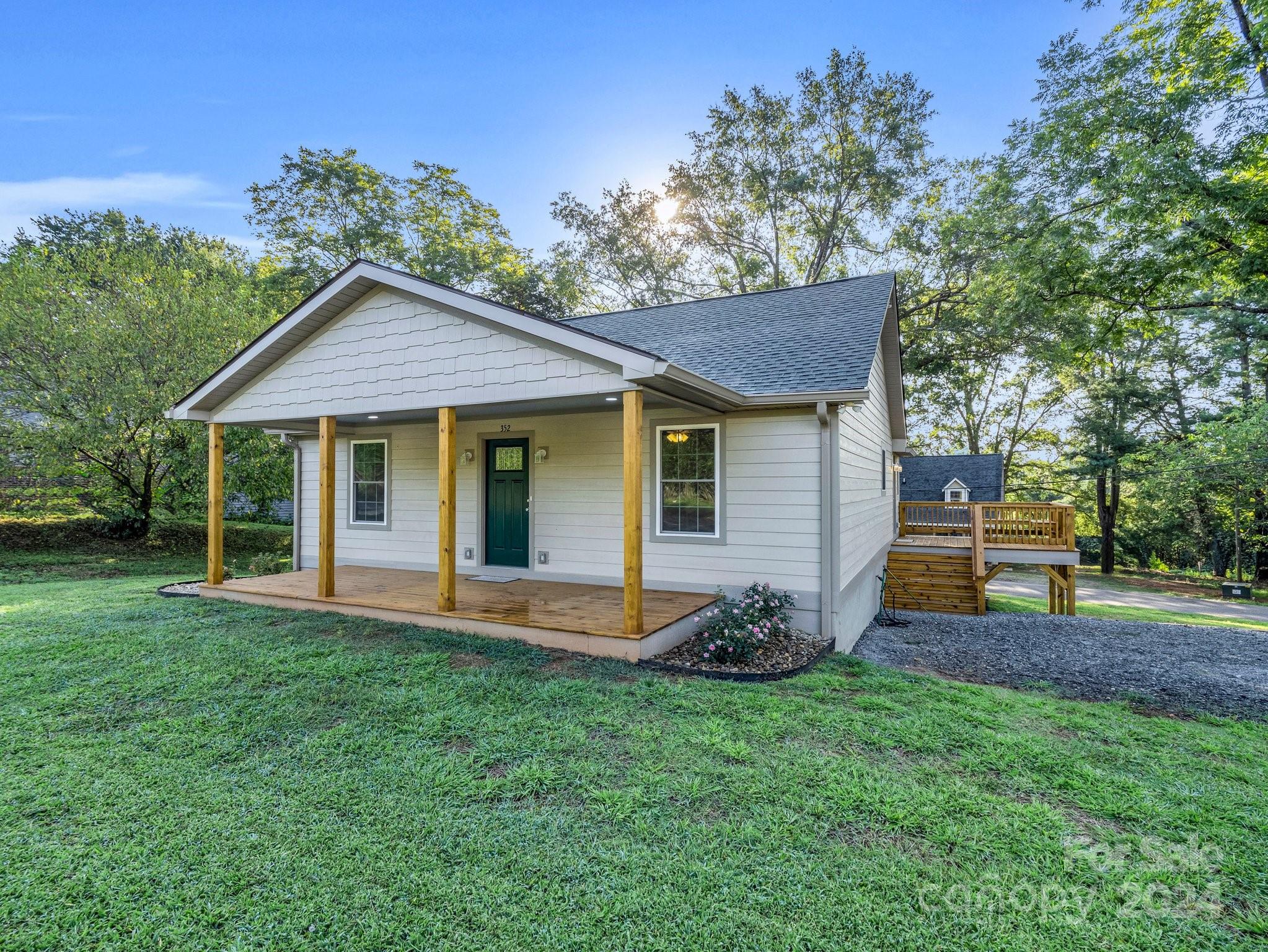 a view of a house with a yard and sitting area