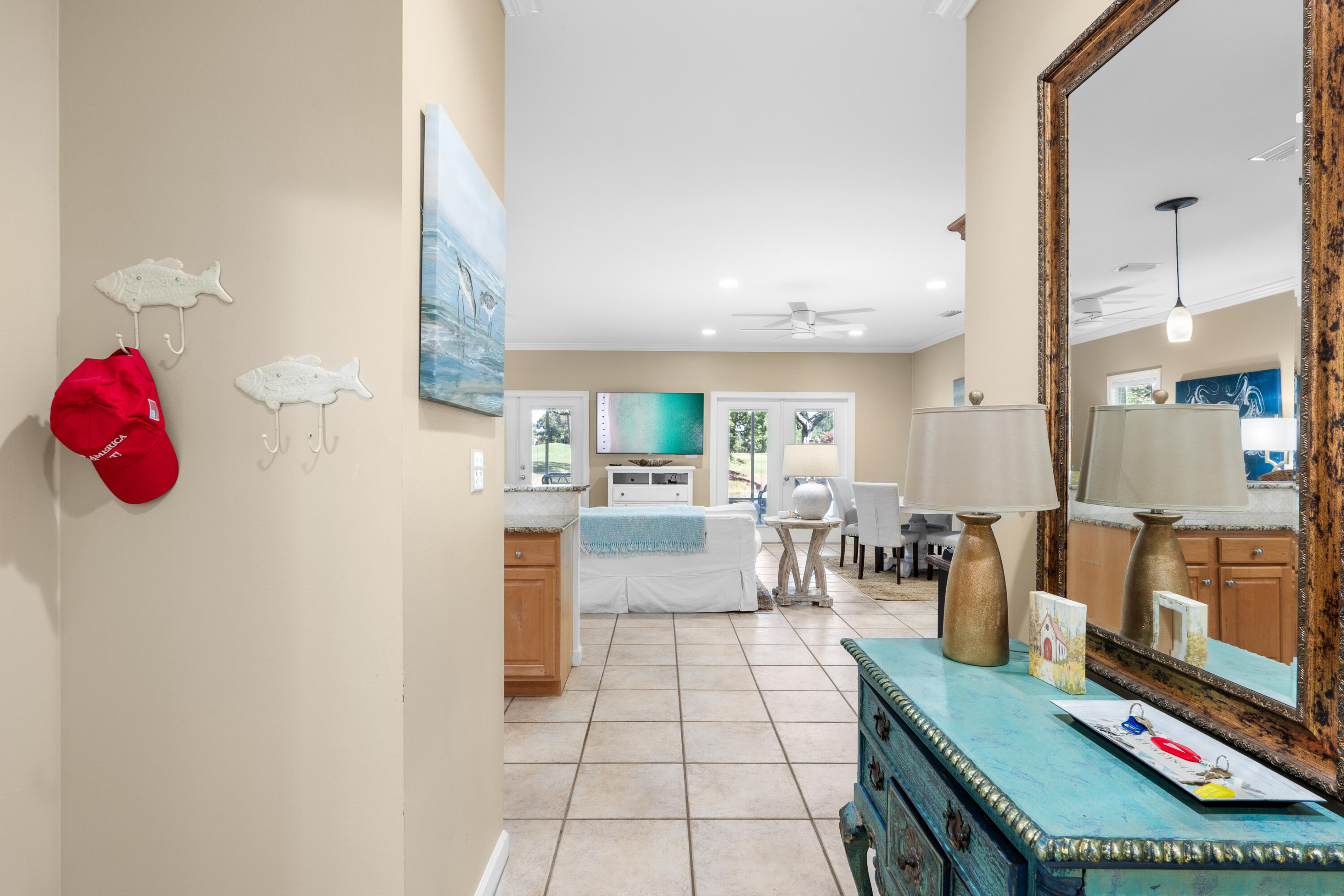 a living room with furniture a flat screen tv and kitchen view