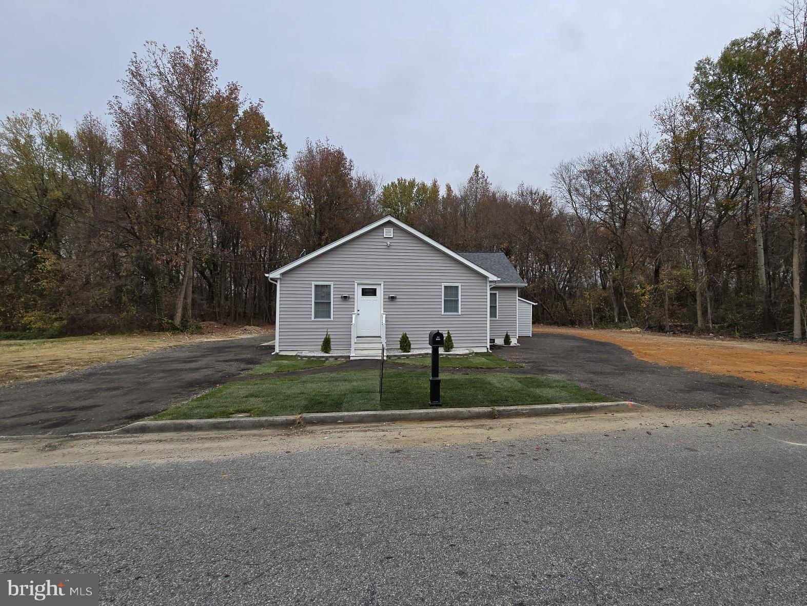 a view of backyard of house and garage