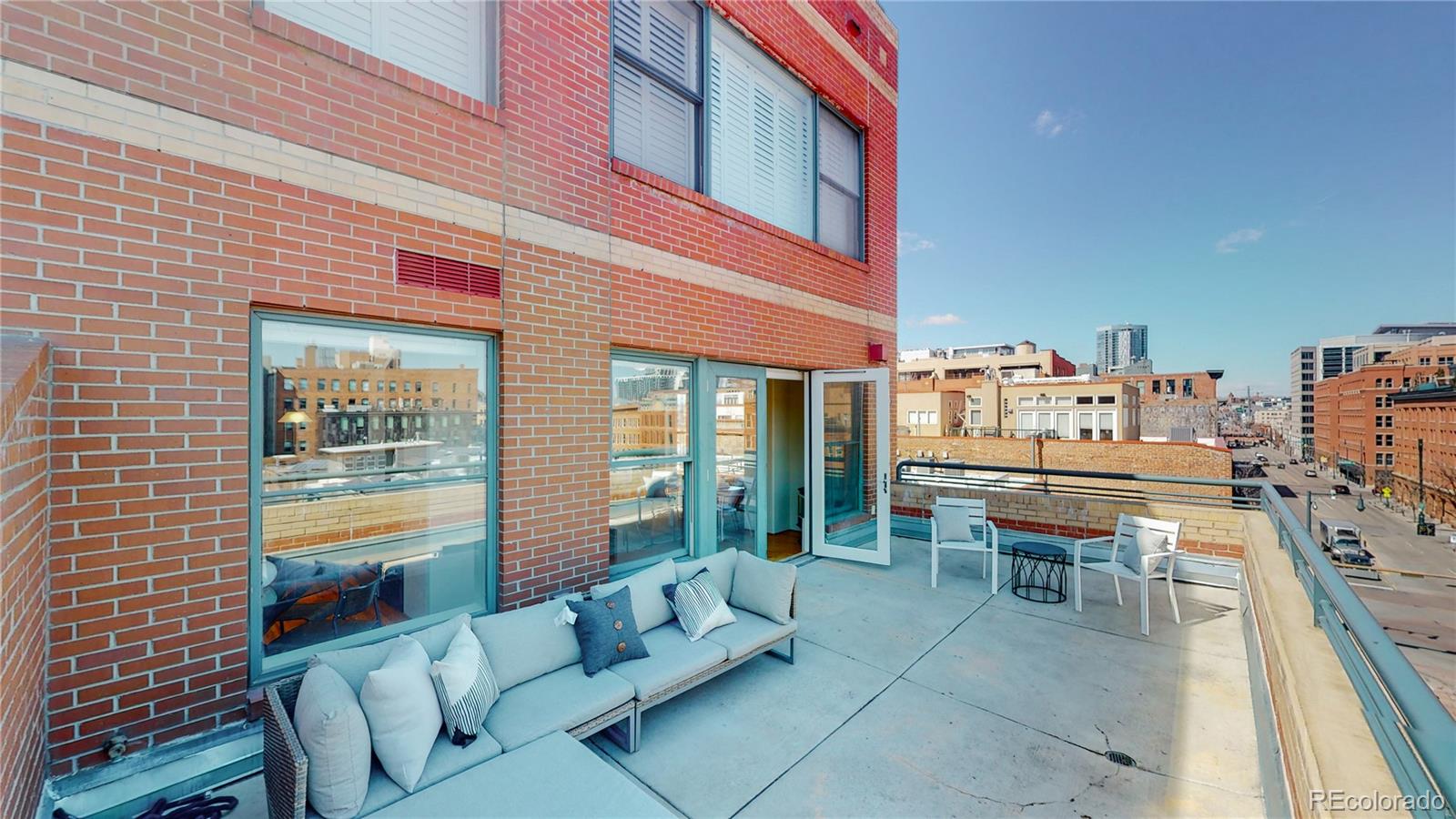 a balcony with furniture and a potted plant