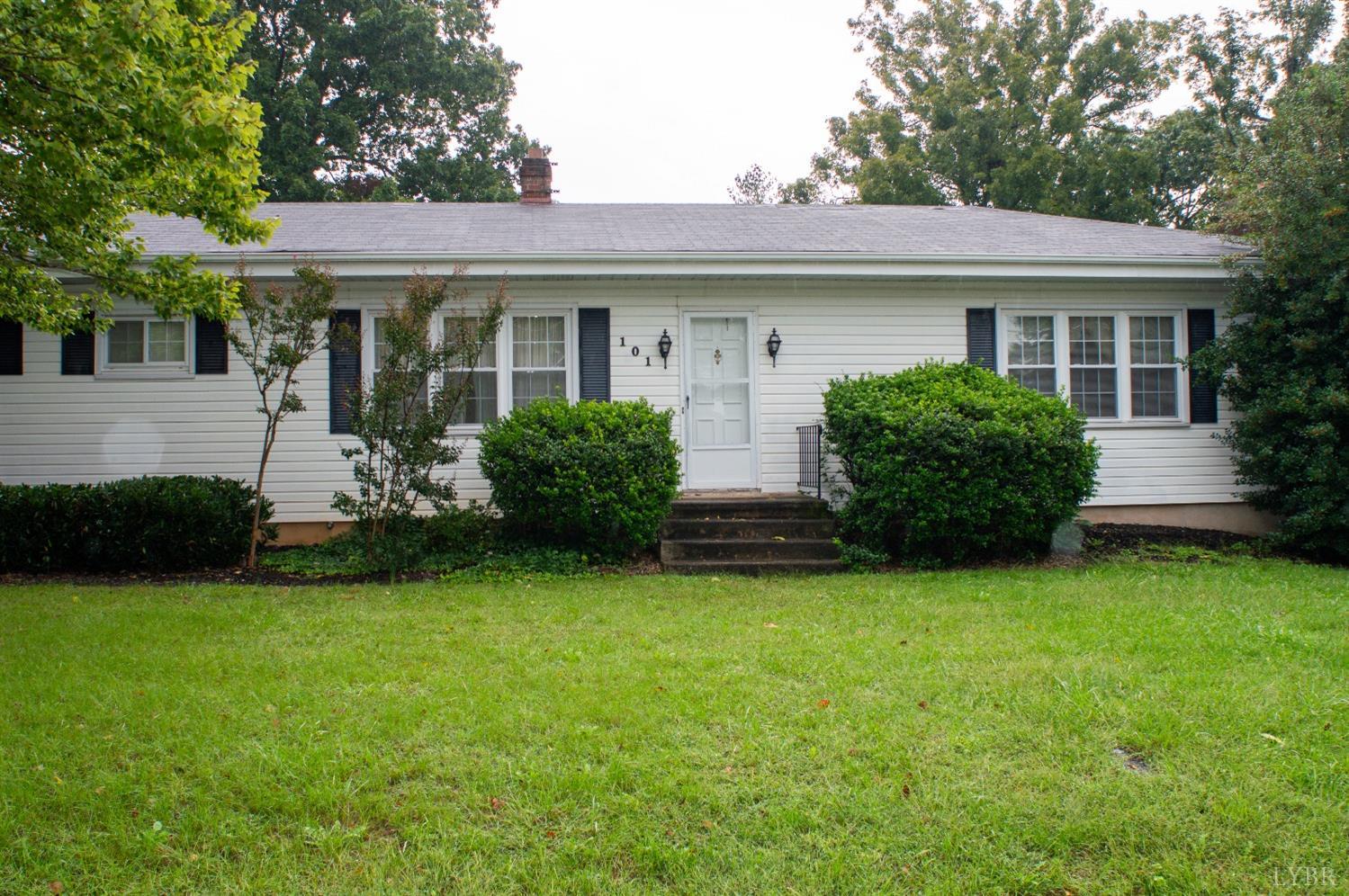 a view of a house with backyard sitting area and garden