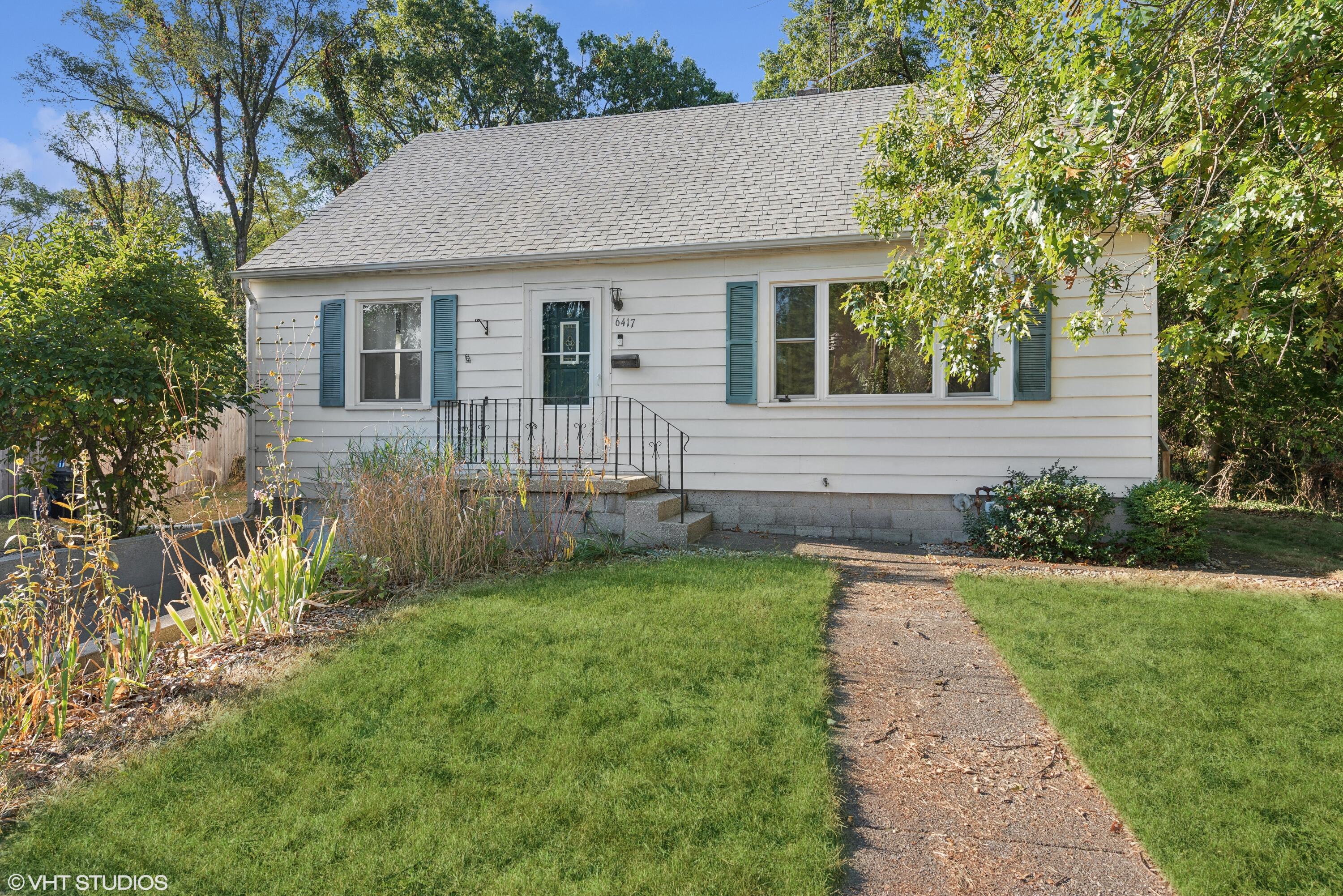 a front view of house with yard and green space