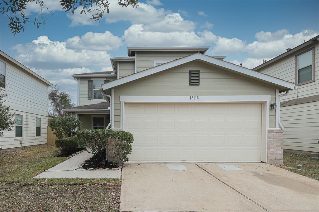 a front view of a house with garage