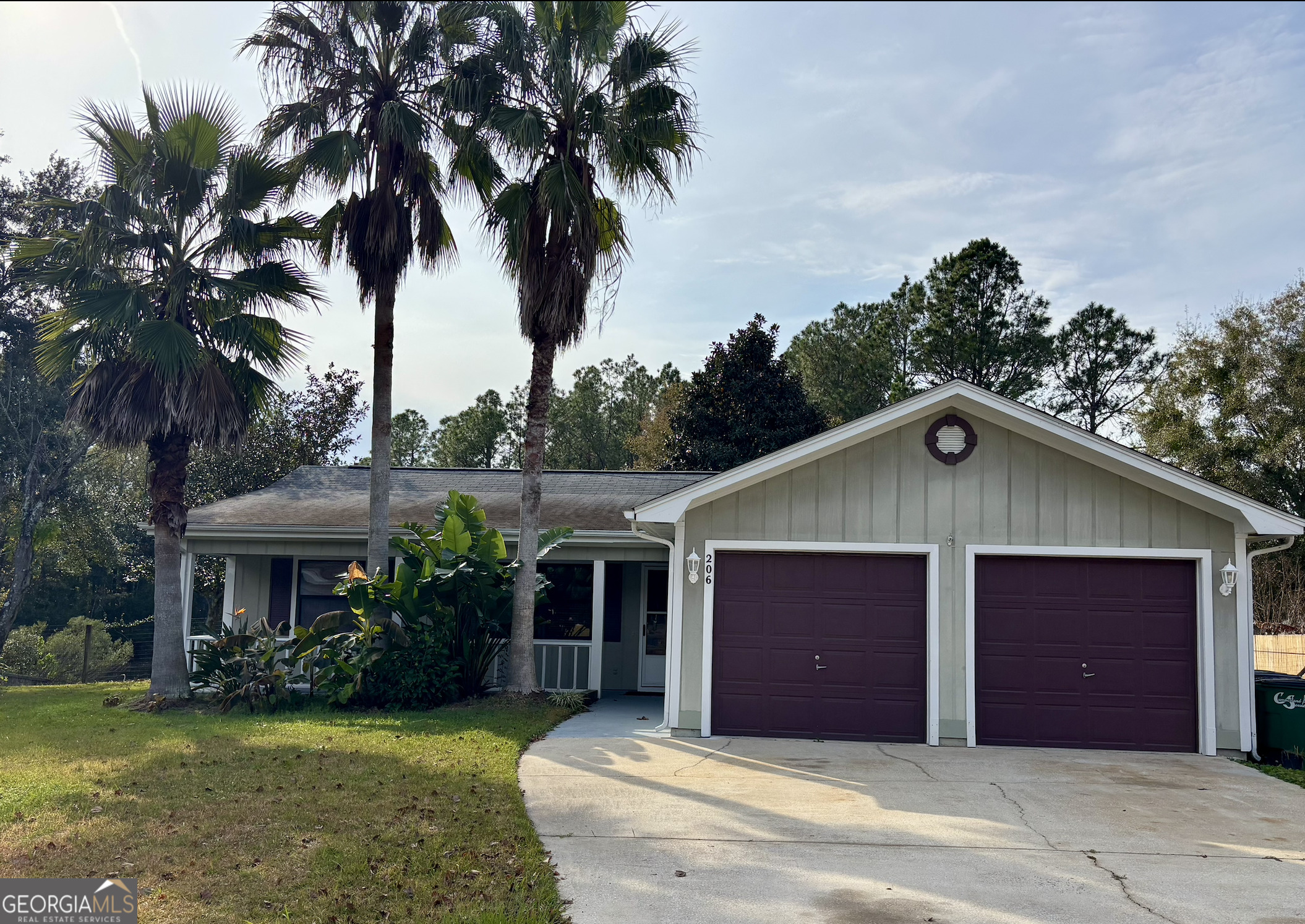 a front view of a house with yard and garage