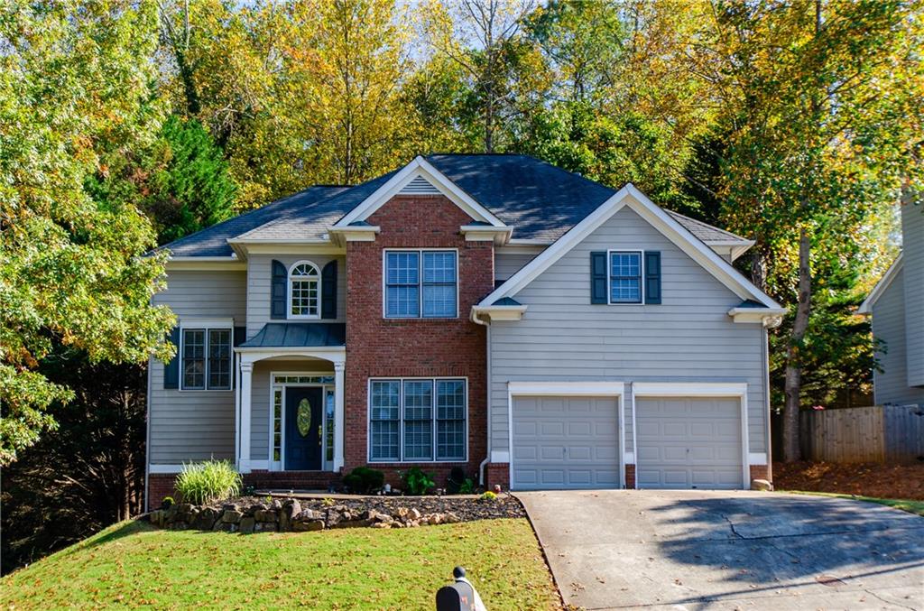 a front view of a house with a yard