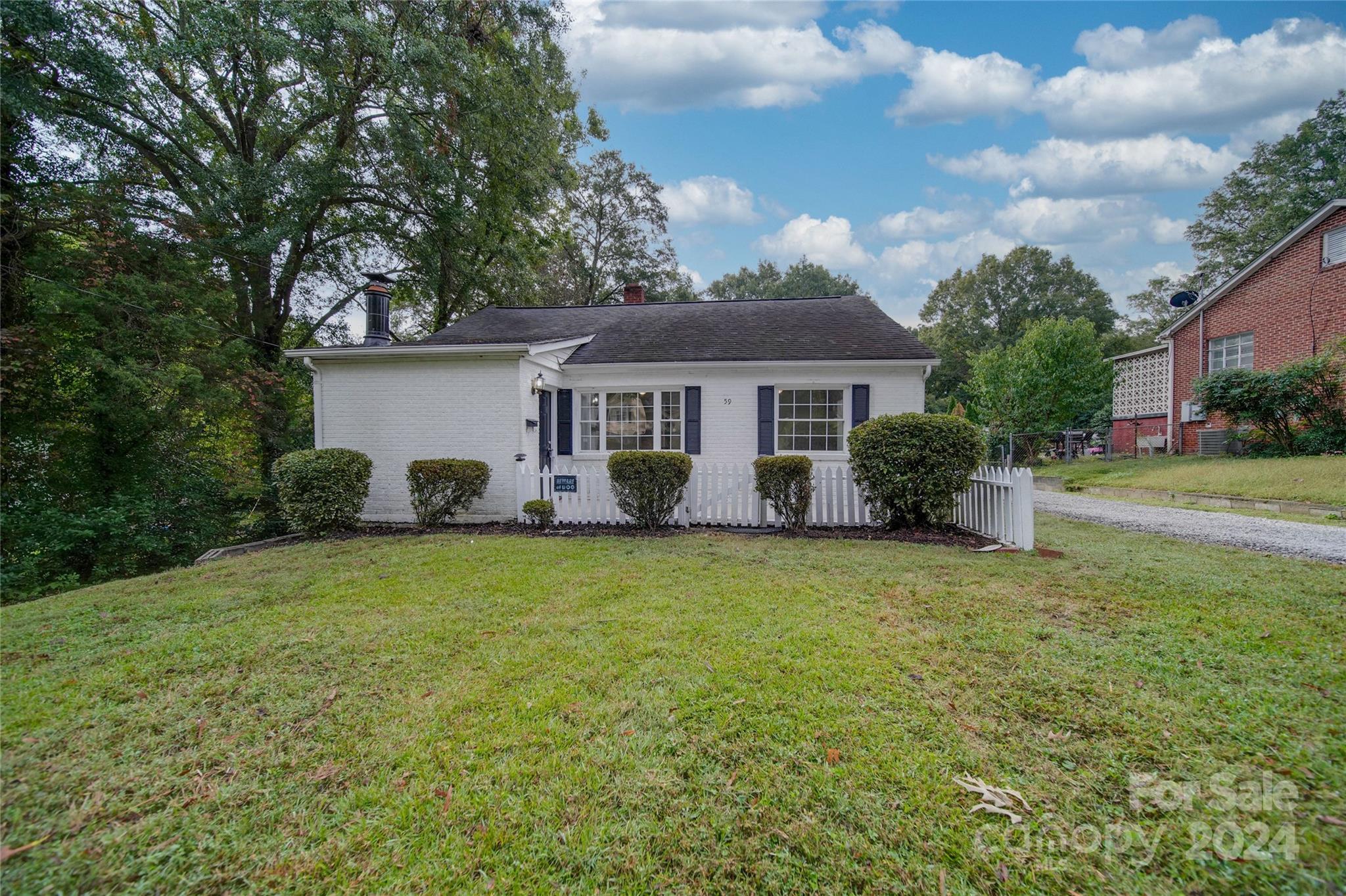 a front view of house with yard and trees