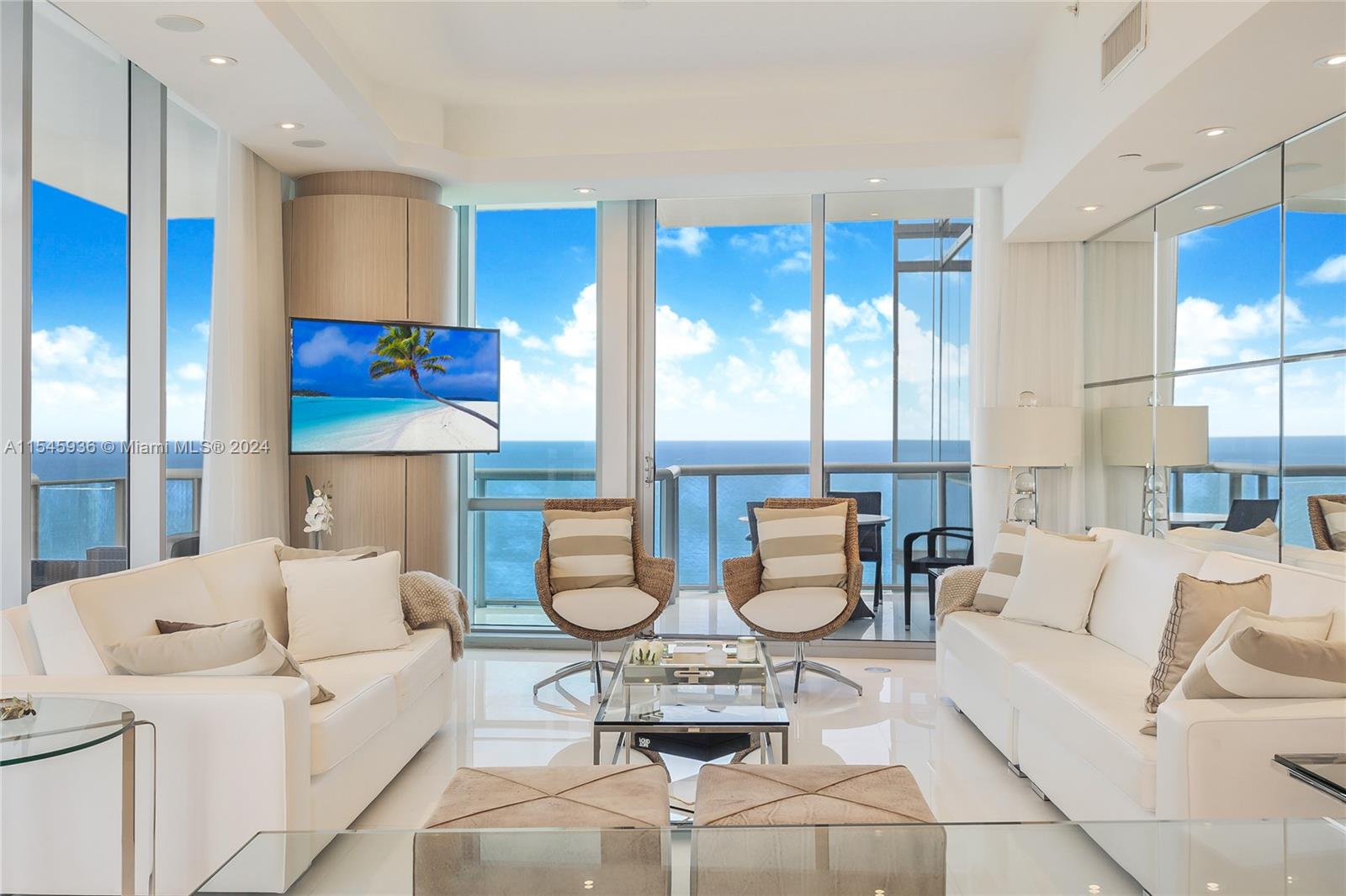 a living room with furniture and kitchen view