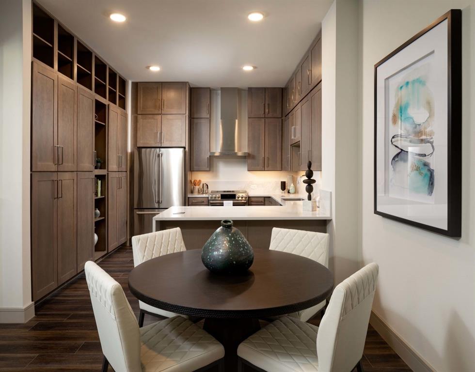 a kitchen with a dining table and refrigerator