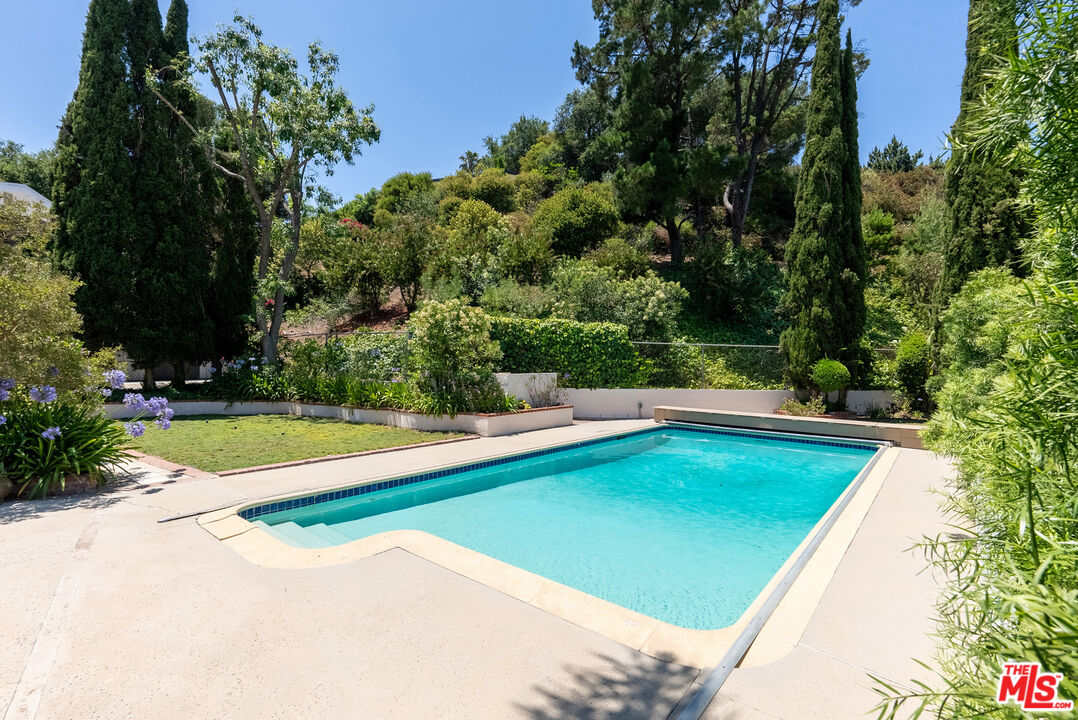 a view of a swimming pool with an outdoor space and seating area