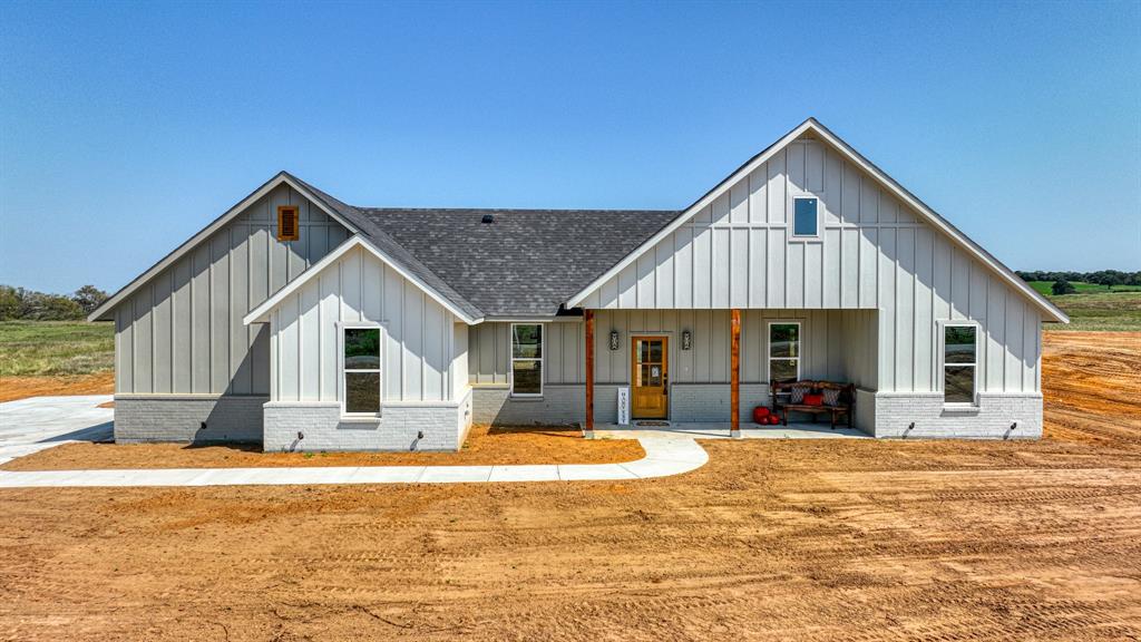 a front view of house with yard outdoor seating and barbeque oven