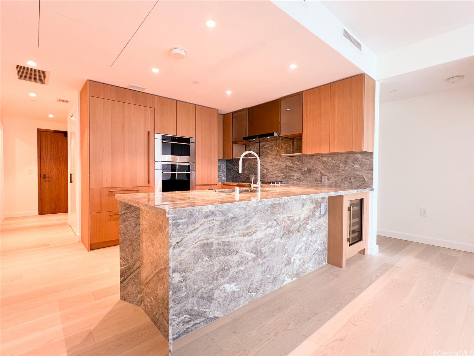 a kitchen with stainless steel appliances kitchen island granite countertop a sink and cabinets