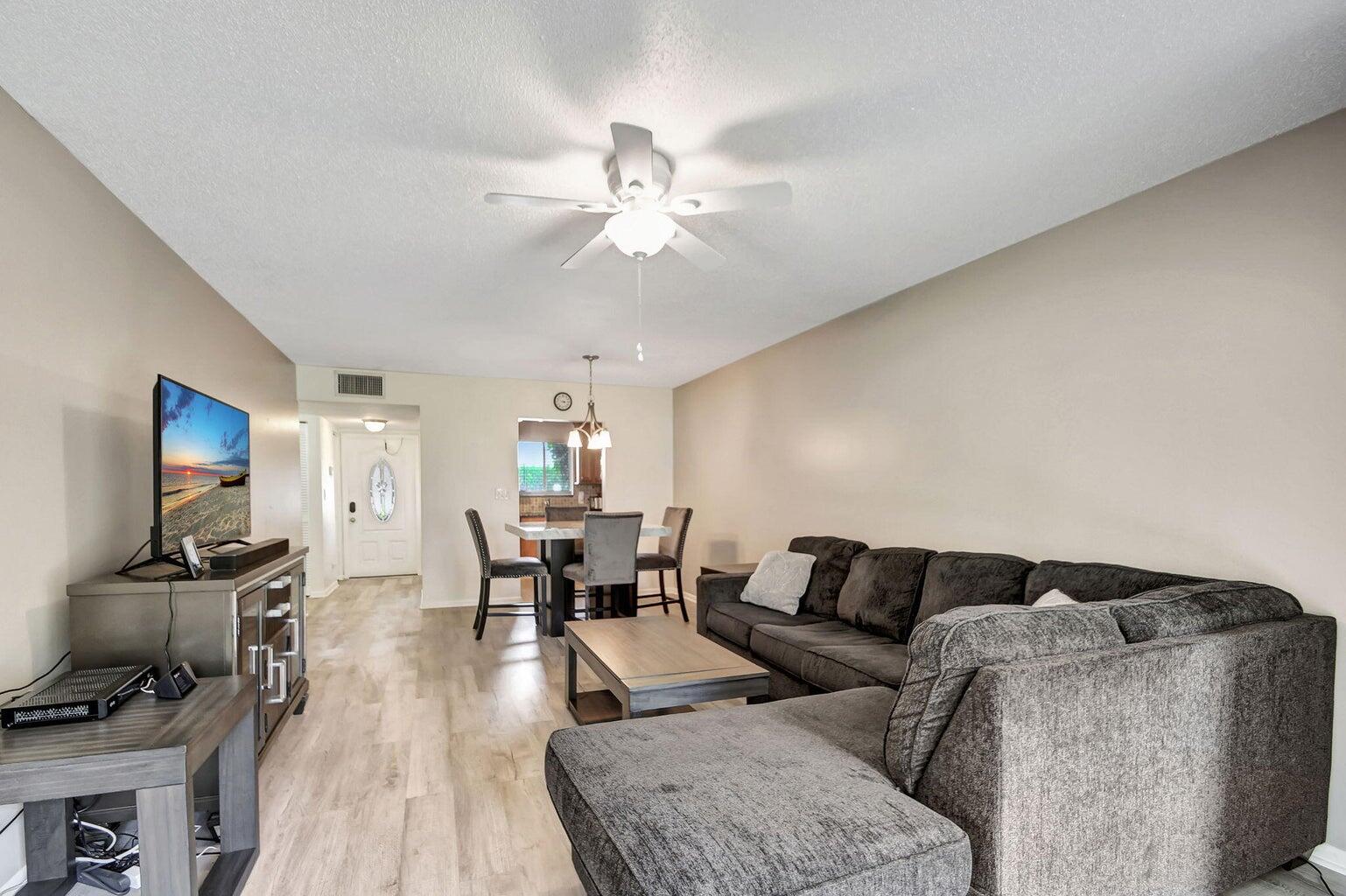 a living room with furniture and wooden floor