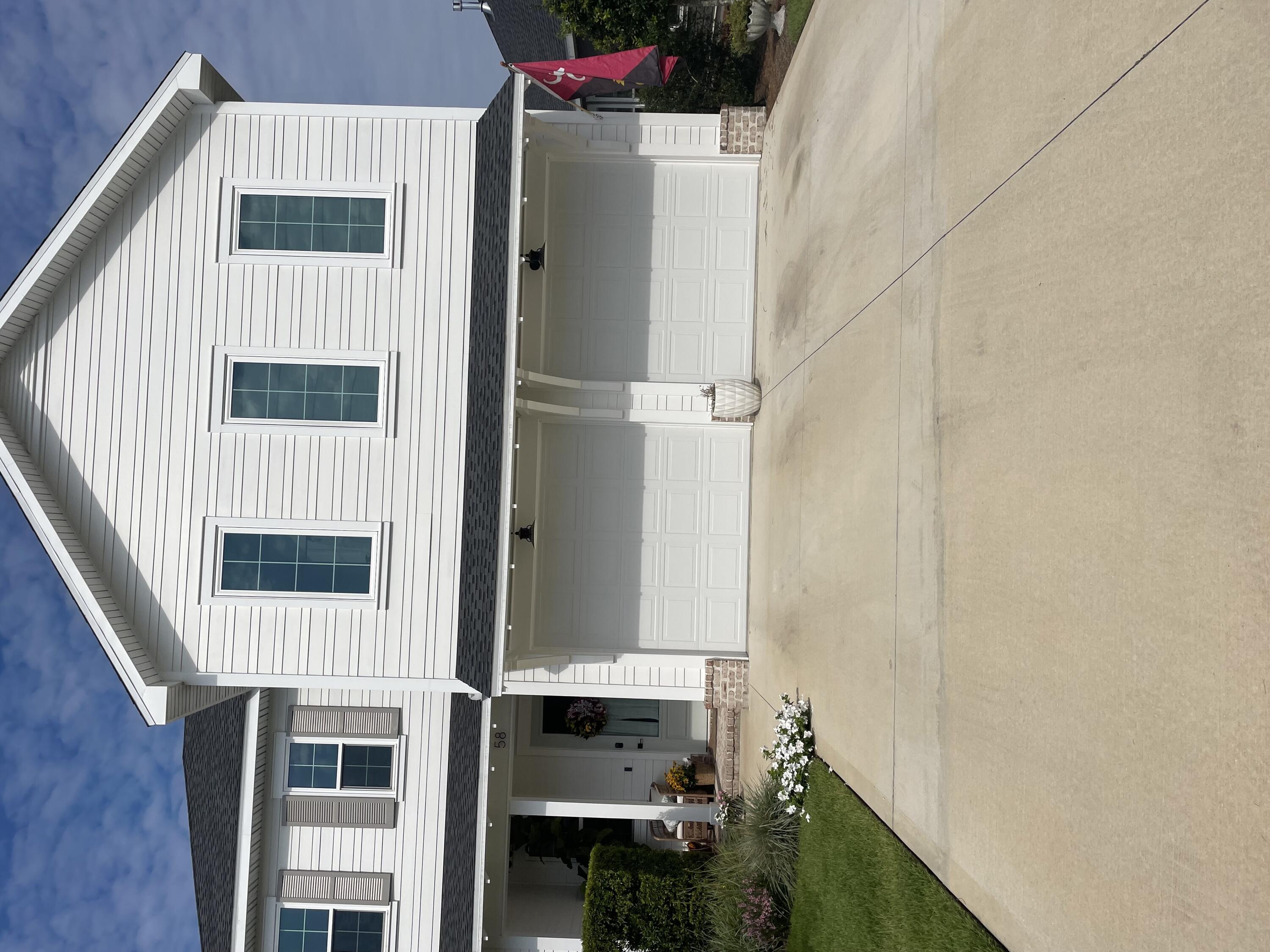 a view of the house with a yard and garage