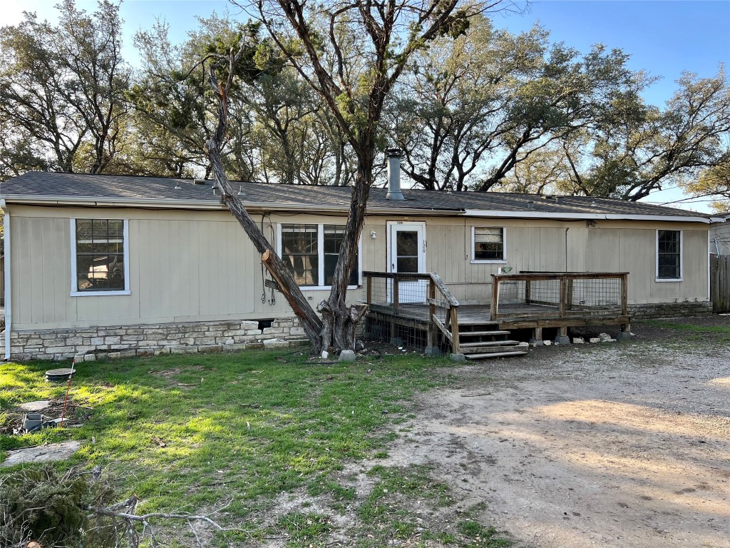 a view of a house with a yard and sitting area